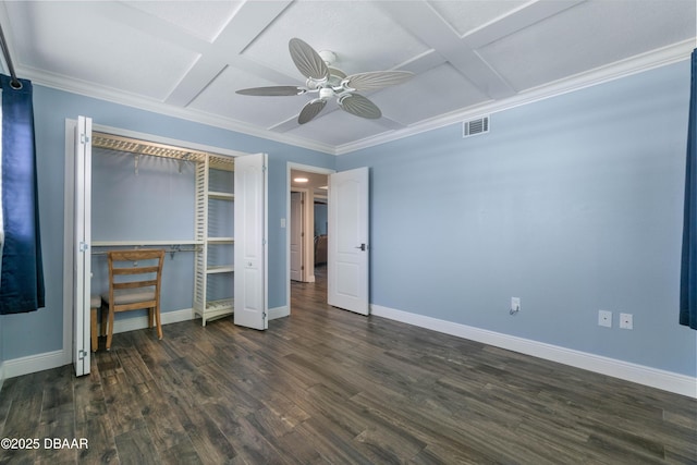 unfurnished bedroom with coffered ceiling, ceiling fan, a closet, dark hardwood / wood-style flooring, and ornamental molding