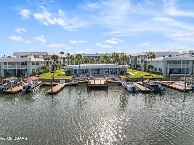 dock area with a lawn and a water view