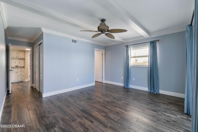 unfurnished room with ceiling fan, dark hardwood / wood-style floors, crown molding, and beamed ceiling