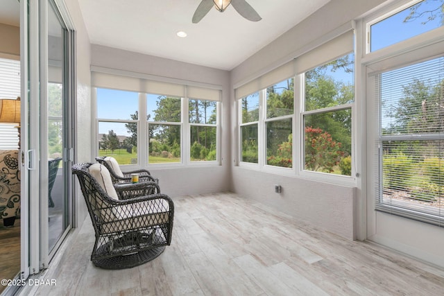 sunroom / solarium with a ceiling fan and a wealth of natural light