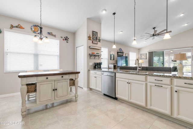 kitchen featuring a ceiling fan, hanging light fixtures, vaulted ceiling, stainless steel dishwasher, and a sink