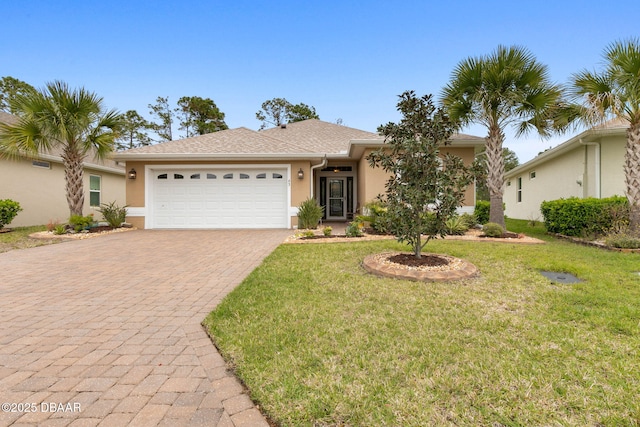 single story home with a front yard, decorative driveway, an attached garage, and stucco siding