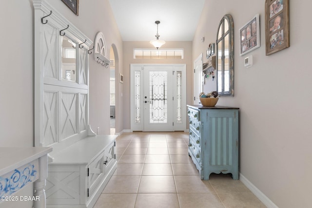 mudroom with baseboards and light tile patterned floors