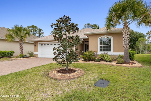 single story home featuring an attached garage, a front yard, decorative driveway, and stucco siding