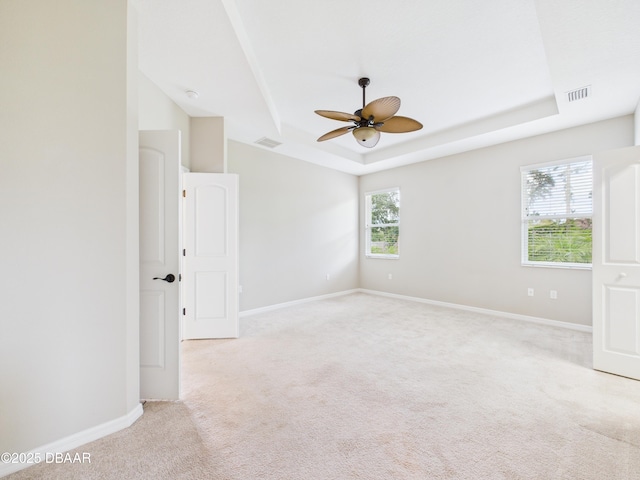 63 Park Place Cir, Palm Coast, FL 32164 - unfurnished room with a tray ceiling, ceiling fan, light carpet, and baseboards