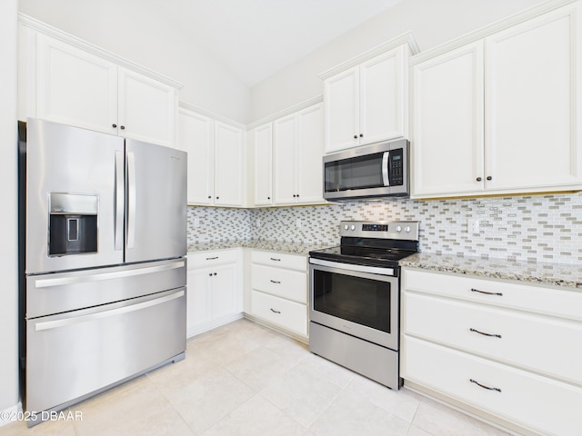 63 Park Place Cir, Palm Coast, FL 32164 - kitchen with stainless steel appliances, light stone counters, decorative backsplash, and white cabinetry