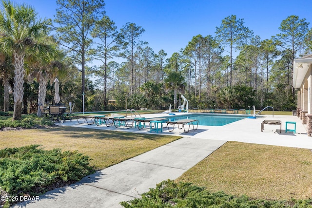 63 Park Place Cir, Palm Coast, FL 32164 - community pool featuring a lawn, a patio area, and view of scattered trees