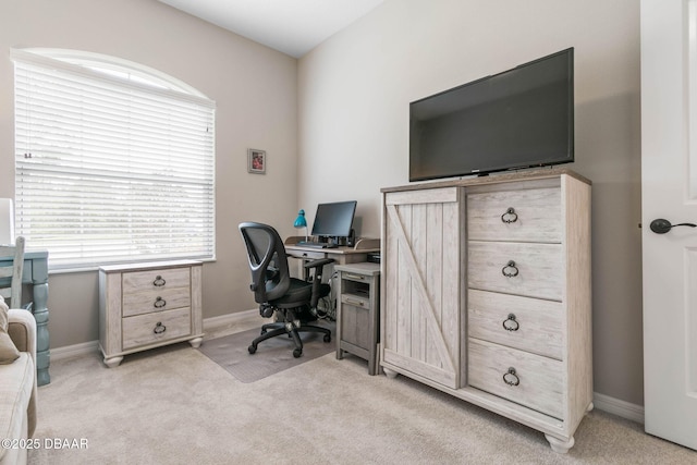 office space with a wealth of natural light, light carpet, and baseboards