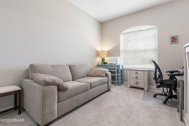 office space featuring baseboards and light colored carpet