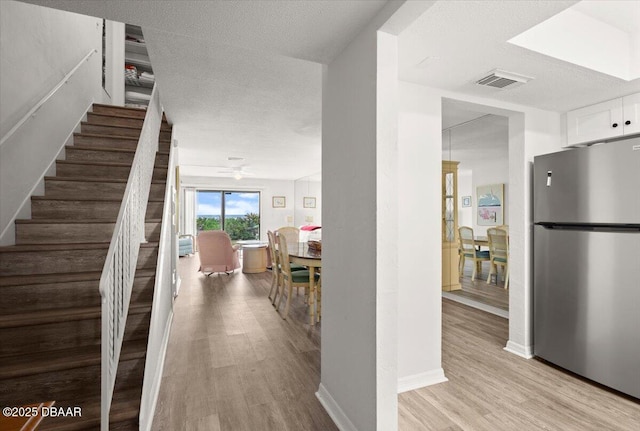 interior space with ceiling fan, hardwood / wood-style floors, and a textured ceiling