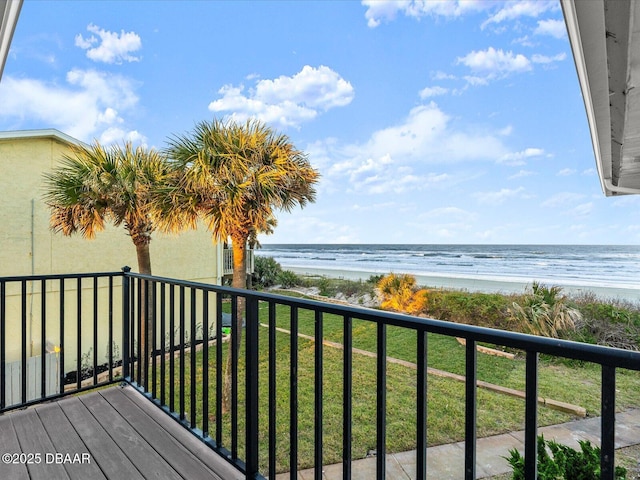 balcony with a water view and a beach view