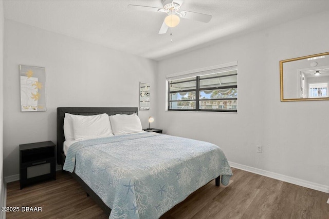 bedroom featuring ceiling fan and dark hardwood / wood-style flooring