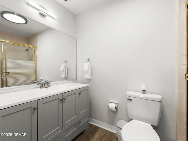 bathroom featuring an enclosed shower, hardwood / wood-style floors, vanity, and toilet