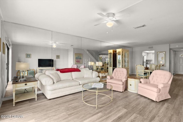 living room with ceiling fan and hardwood / wood-style floors