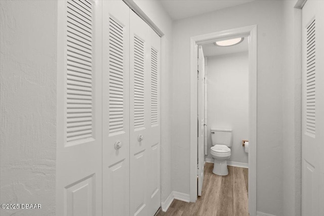 bathroom featuring hardwood / wood-style flooring and toilet