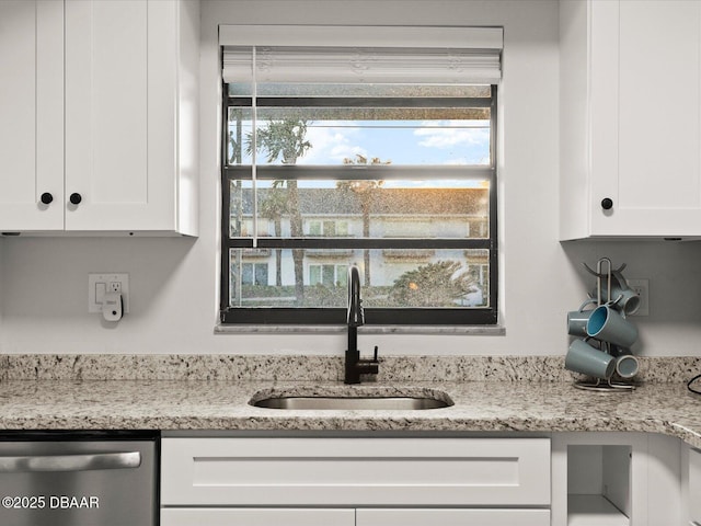 details with white cabinetry, sink, and dishwasher