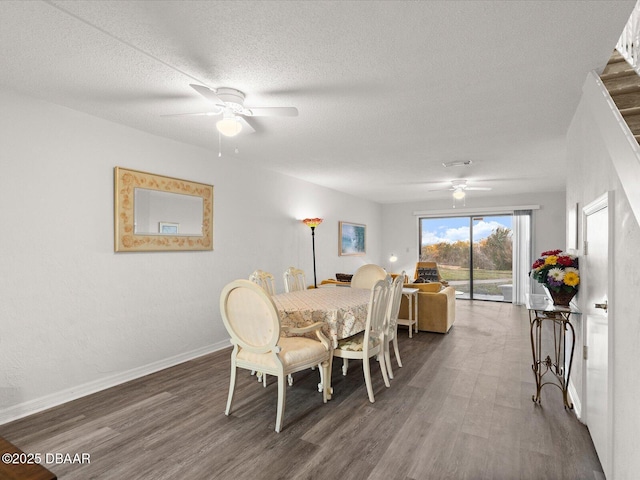 dining area with dark hardwood / wood-style floors, a textured ceiling, and ceiling fan