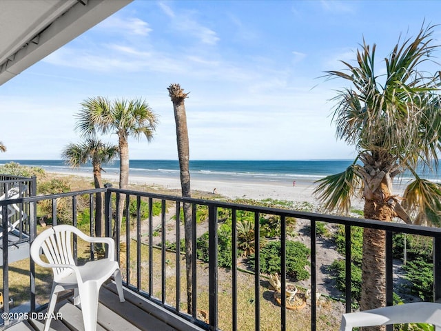 balcony featuring a beach view and a water view