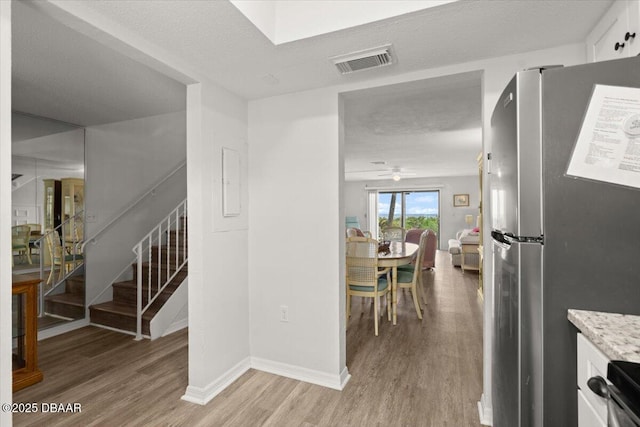 interior space featuring light hardwood / wood-style floors and a textured ceiling