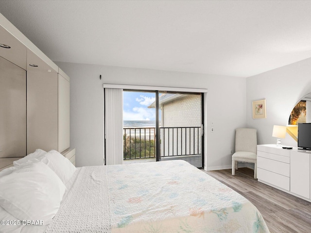 bedroom featuring light hardwood / wood-style flooring and access to outside