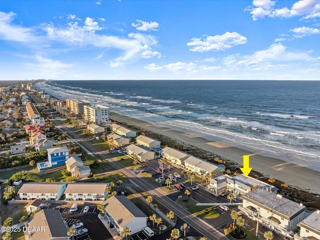 birds eye view of property with a water view and a view of the beach