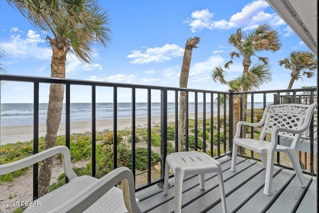 balcony with a water view and a beach view