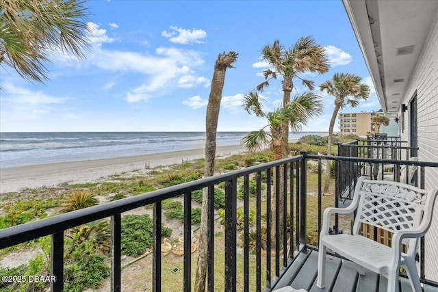 balcony featuring a water view and a beach view