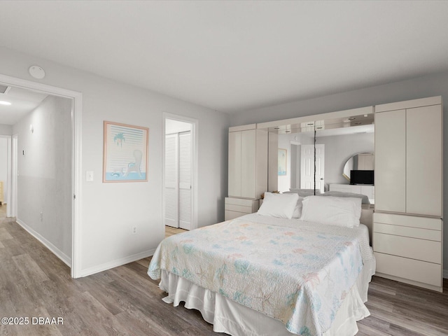 bedroom featuring light hardwood / wood-style floors and a closet