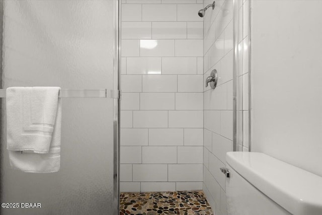 bathroom featuring an enclosed shower and toilet