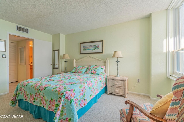 bedroom featuring a textured ceiling and carpet floors