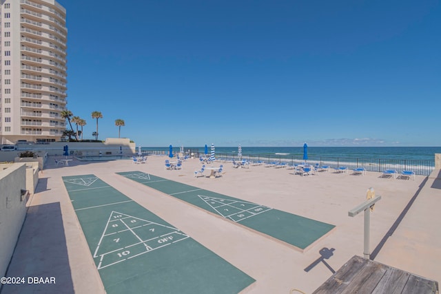 view of property's community with a beach view and a water view