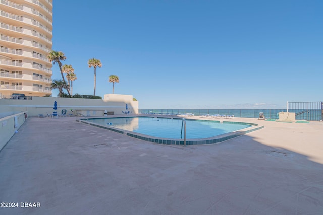 view of pool featuring a water view