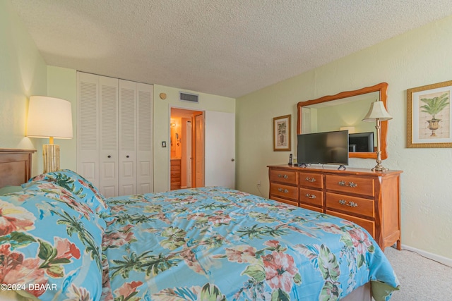 carpeted bedroom with a textured ceiling and a closet