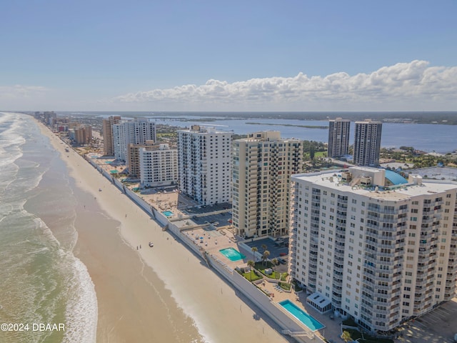 bird's eye view featuring a water view and a beach view