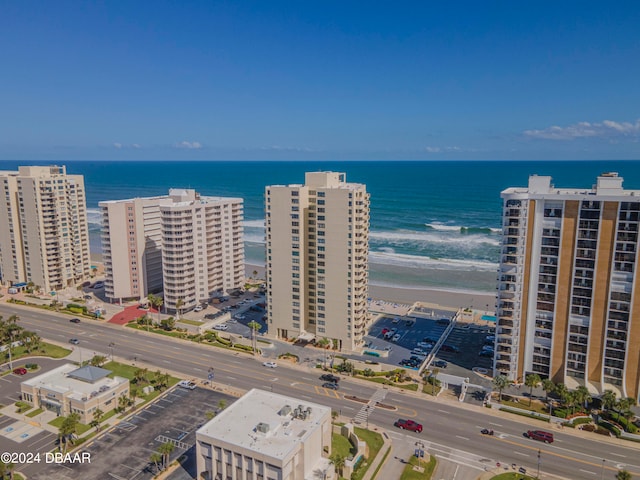 bird's eye view with a water view and a beach view