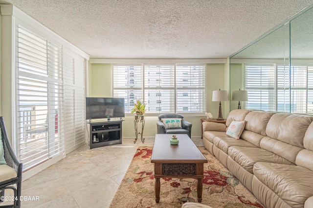 tiled living room featuring a wealth of natural light and a textured ceiling