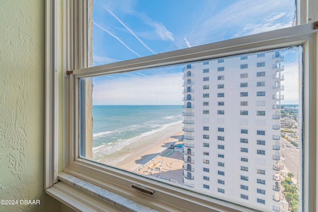 interior details featuring a view of the beach and a water view