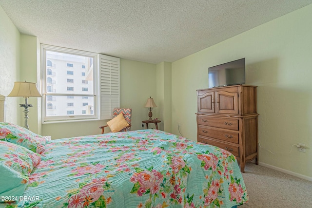 bedroom with a textured ceiling and carpet floors