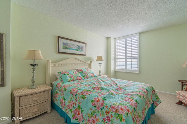 carpeted bedroom with a textured ceiling