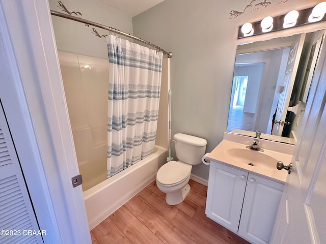 full bathroom featuring shower / tub combo with curtain, vanity, toilet, and hardwood / wood-style floors