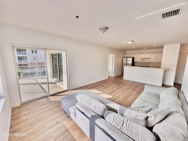 living room with light hardwood / wood-style flooring