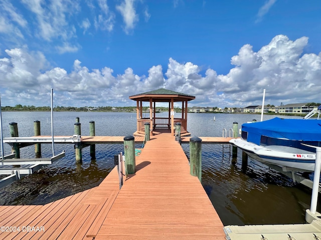 view of dock with a gazebo and a water view