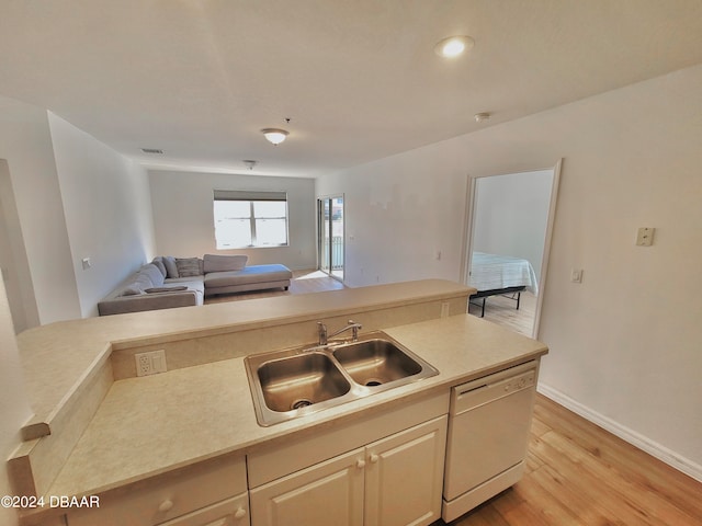 kitchen featuring white dishwasher, light hardwood / wood-style floors, and sink