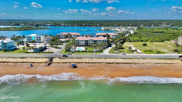 bird's eye view with a water view and a view of the beach