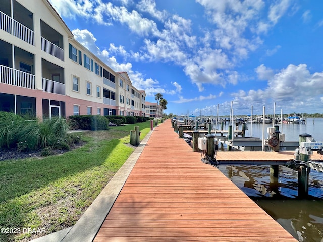 view of dock featuring a yard and a water view