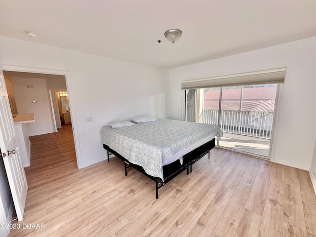 bedroom with light wood-type flooring and access to outside