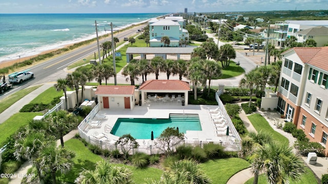 birds eye view of property with a water view and a beach view