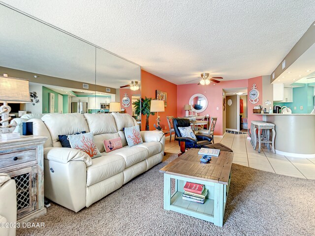 living room with tile patterned flooring and a textured ceiling