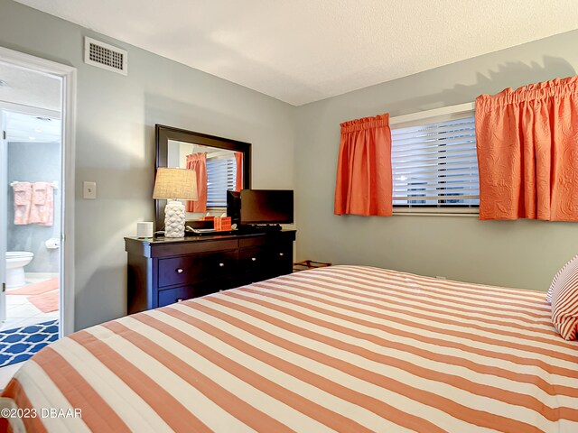 bedroom with connected bathroom