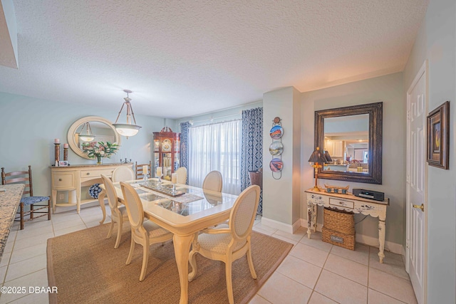 dining room featuring a textured ceiling and light tile patterned floors